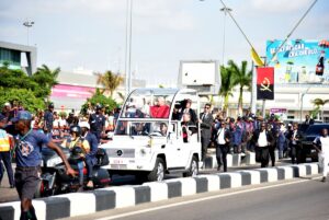 Faithfuls cheer as Pope Leo XIV (C) waves at them from the Popemobile after his arrival at the "4 de Fevereiro" Luanda International Airport in Luanda on the sixth day of an 11-day apostolic journey to Africa, on April 18, 2026. PHOTO: AFP/ JULIO PACHECO NTELA