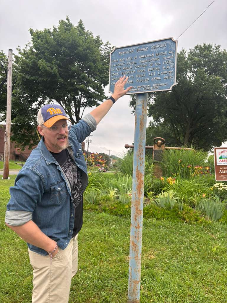 Jason Hank, an American citizen, shows the main entrance of Ambridge.